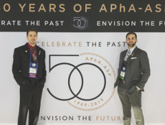 Jordan Scott in front of APhA-ASP 50th Anniversary Sign
