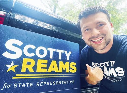Scotty Reams pointing to State Representative auto decal.