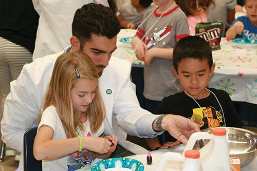 D'Antonio working with children at table