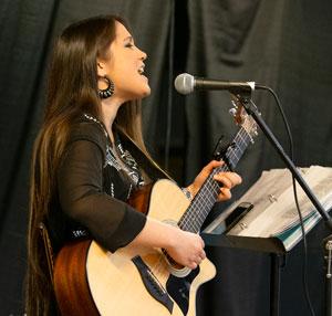 Alicia Bautista playing guitar