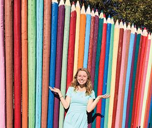 Emily in front of giant colored pencils