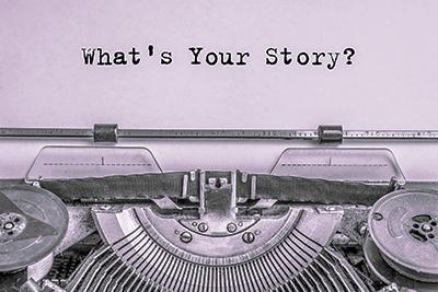 'What's Your Story' typed on paper in typewriter.